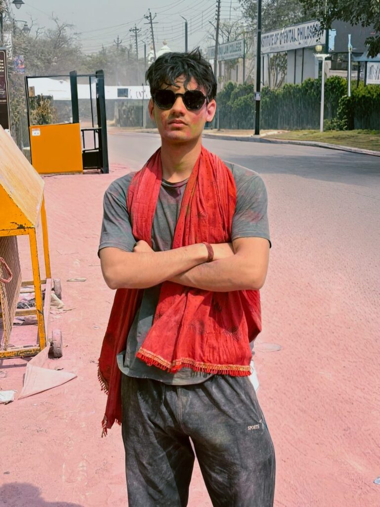 Best GYM in East Delhi | Club9gym Young man wearing sunglasses and red scarf posing outdoors client of club9 gym best gym in east delhi